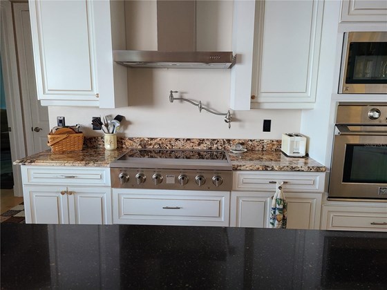 There is a faucet that allows you to easily fill your pots with water while they are on the stove. - Single Family Home for sale at 1900 Illinois Ave, Englewood, FL 34224 - MLS Number is D6121965