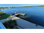This view of the dock was taken from the deck. - Single Family Home for sale at 1900 Illinois Ave, Englewood, FL 34224 - MLS Number is D6121965
