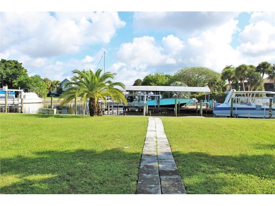Large back yard with dock and boat lift - Single Family Home for sale at 1345 Holiday Dr, Englewood, FL 34223 - MLS Number is C7449205