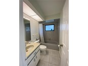 Guest bathroom with a tub/shower combo. - Single Family Home for sale at 18506 Hottelet Cir, Port Charlotte, FL 33948 - MLS Number is C7452138
