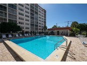 View of your heated pool with the clubhouse in the rear - Condo for sale at 244 Saint Augustine Ave #104, Venice, FL 34285 - MLS Number is A4518081