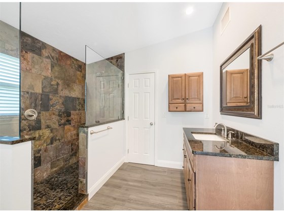 Large ensuite bath in primary bedroom includes a tiled shower and roomy walk-in closet. - Single Family Home for sale at 3070 Hatton St, Sarasota, FL 34237 - MLS Number is A4518301