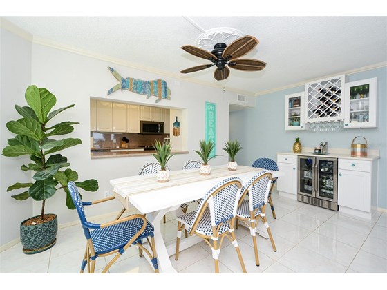 Dining room with service bar and wine refrigerator - Condo for sale at 450 Gulf Of Mexico Dr #B107, Longboat Key, FL 34228 - MLS Number is A4520786